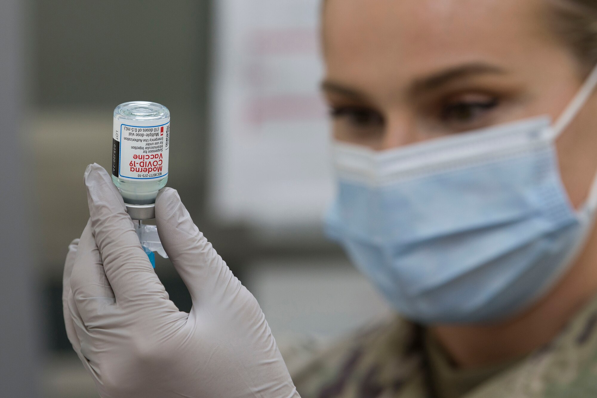 U.S. Air Force Staff Sgt. Bianca Marts, 380th Expeditionary Medical Group (EMDG) medical technician, prepares to administer a voluntary COVID-19 vaccine at Al Dhafra Air Base, United Arab Emirates, Jan. 24, 2021.