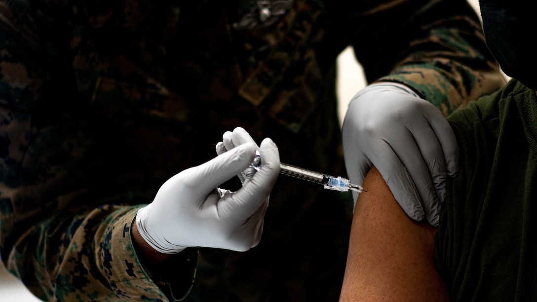 A U.S. Navy corpsman administers a U.S. Marine with the Pfizer-BioNTech COVID-19 Vaccine on Camp Lejeune, N.C., Jan. 15.