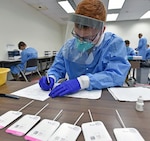Pfc. Jagher Jones with Company A, 232nd Medical Battalion, testing COVID-19 antigen samples.