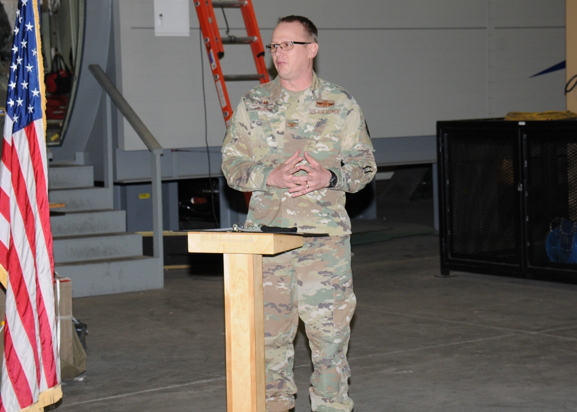 An Air Force officer speaks at a ribbon-cutting ceremony.