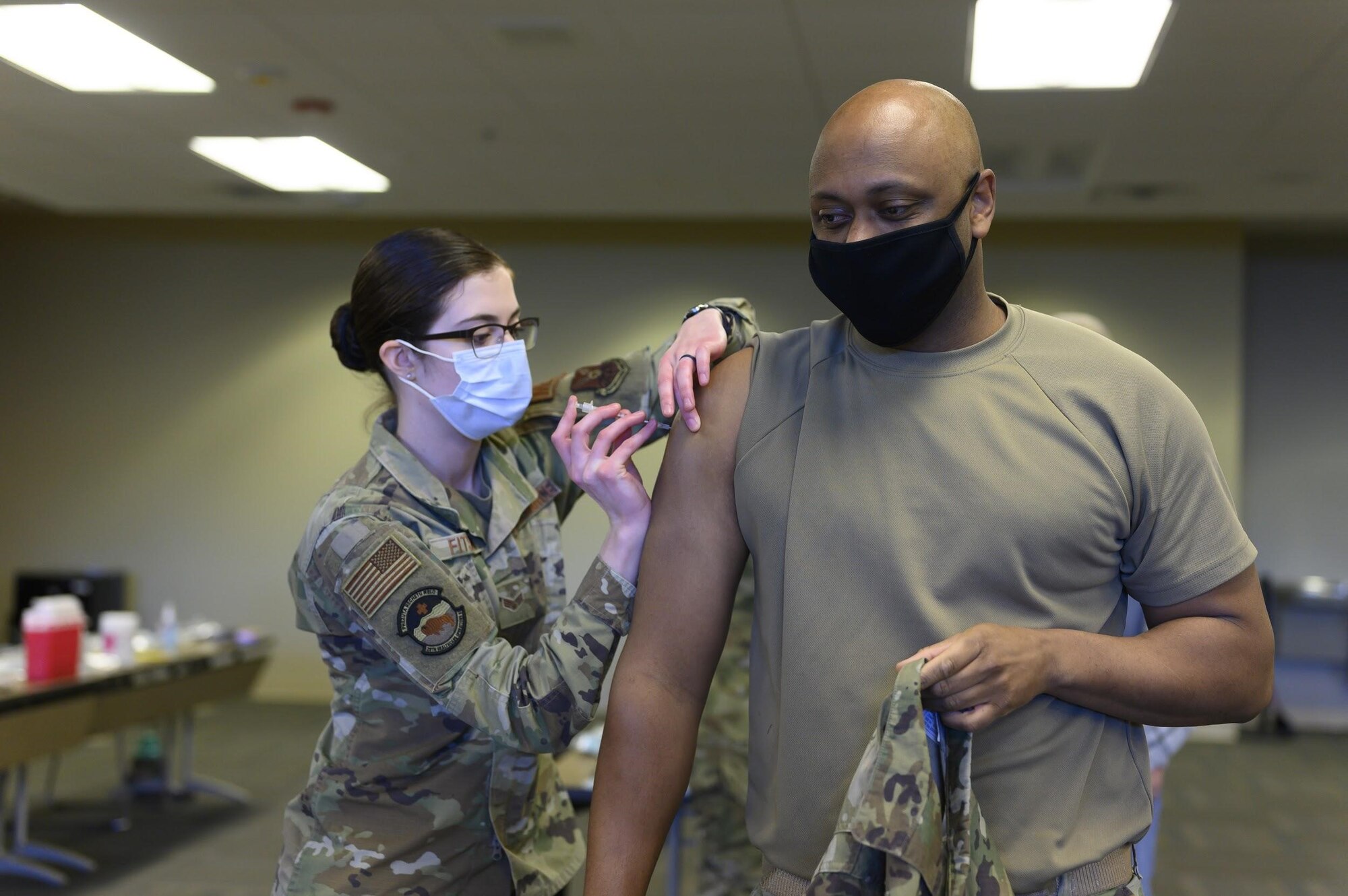 Senior Airman Brittney Fitschen, 28th Health Care Operations Squadron family health technician, administers a COVID-19 vaccine to Lt. Col. David Herndon, 28th Security Forces Squadron commander, at Ellsworth Air Force Base, S.D., Jan. 15, 2021.