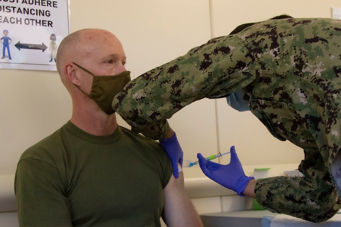 Maj. Gen. James F. Glynn, commander of Marine Forces, Special Operations Command, receives the COVID-19 vaccine at Naval Medical Center Camp Lejeune, Jan. 15, 2020. “The opportunity to protect yourself, your family, friends and our unit is here,” said Glynn. “I encourage all to get vaccinated to ensure you’re ready for every mission - regardless of time or place.” The COVID-19 vaccination plan is phase-driven and designed to safely protect members within the Department of Defense as quickly as possible. (U.S. Marine Corps photo taken by Cpl. Jesula Jeanlouis)