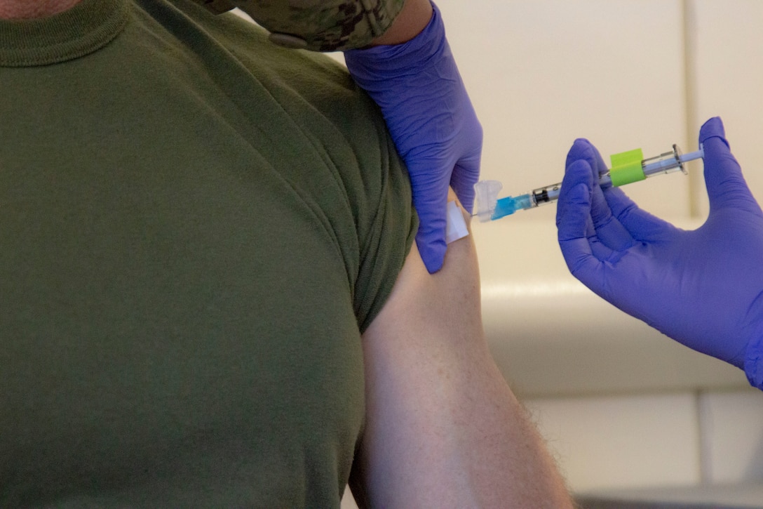 Maj. Gen. James F. Glynn, commander of Marine Forces, Special Operations Command, receives the COVID-19 vaccine at Naval Medical Center Camp Lejeune, Jan. 15, 2020. “The opportunity to protect yourself, your family, friends and our unit is here,” said Glynn. “I encourage all to get vaccinated to ensure you’re ready for every mission - regardless of time or place.” The COVID-19 vaccination plan is phase-driven and designed to safely protect members within the Department of Defense as quickly as possible. (U.S. Marine Corps photo taken by Cpl. Jesula Jeanlouis)