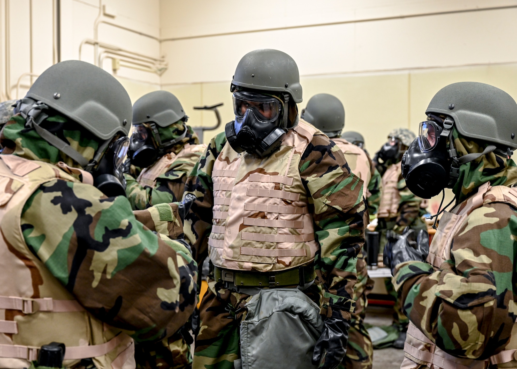 Airmen don MOPP gear.