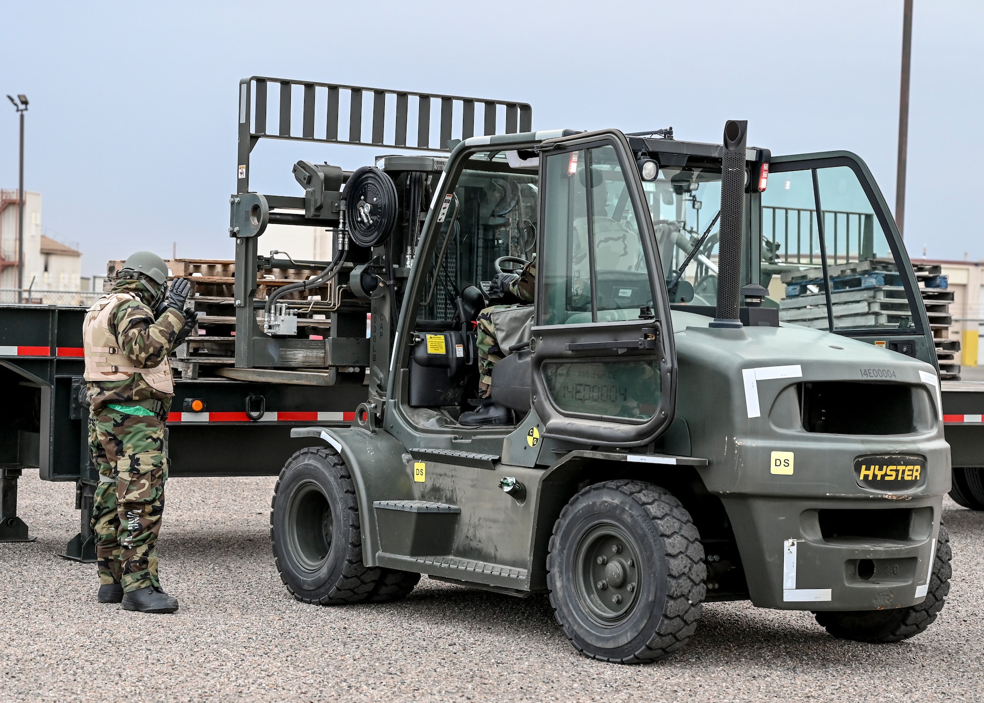 Airmen operate a forklift.