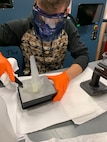 Adrian Wos, mechanical engineer for the Navy’s Mid-Atlantic Regional Maintenance Center (MARMC) and the Naval Acquisition Development Program (NADP), cleans and post-processes a 3D printer-made, model-scale propeller. Wos is one of two interns participating in NSWC PHD’s In-Service Engineering Agent collaboration with MARMC and NADP’s virtual internship program.