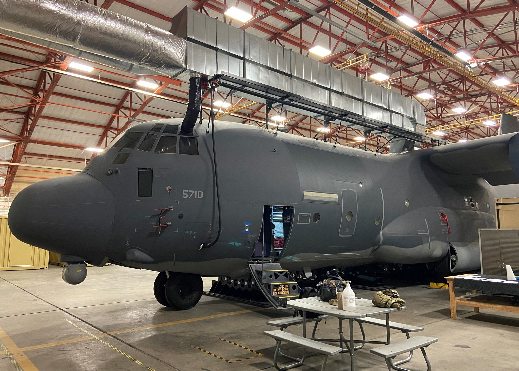 A C-130 ground trainer is installed in a hangar.
