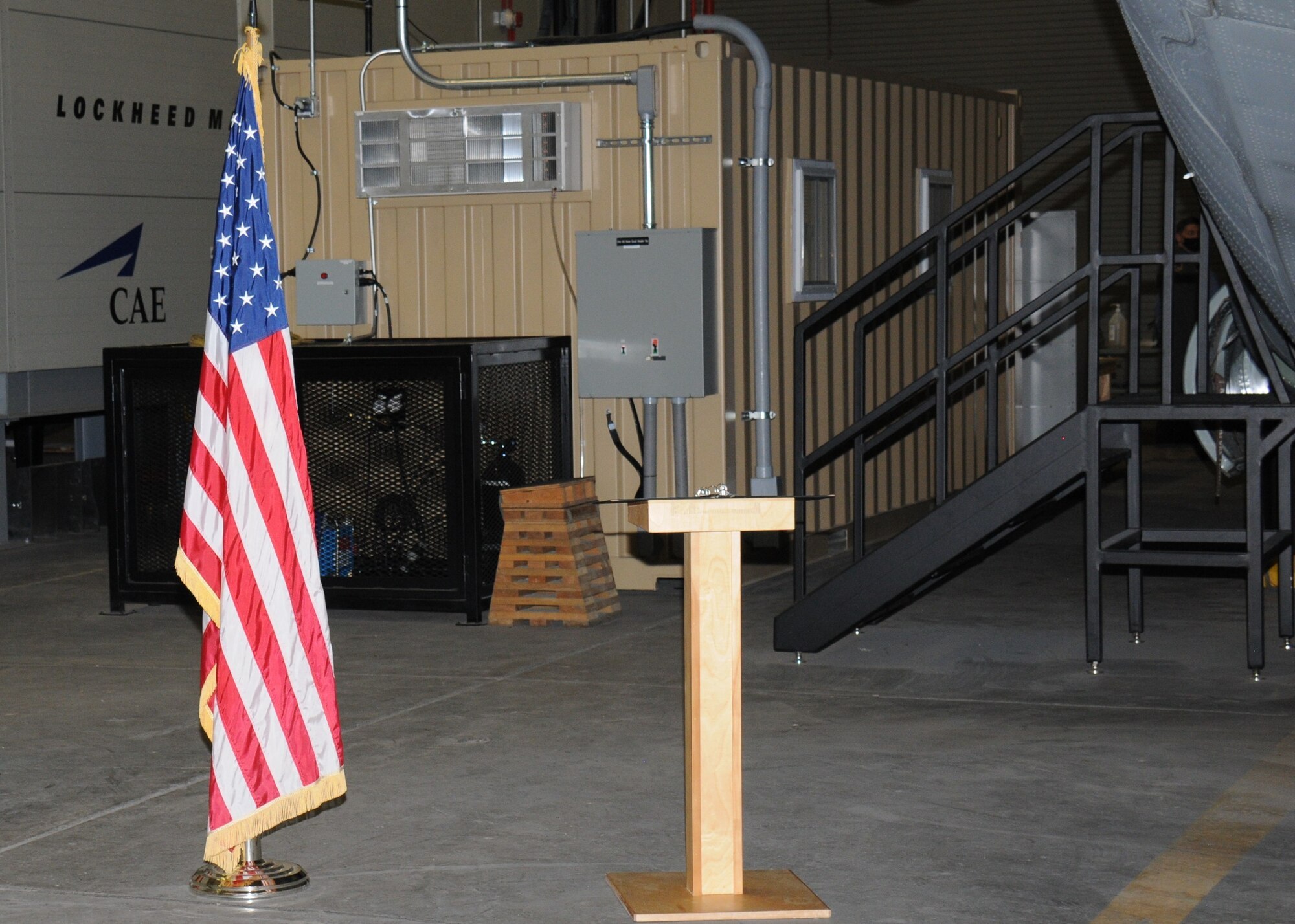 A structure is attached to a ground training device inside an aircraft hangar.