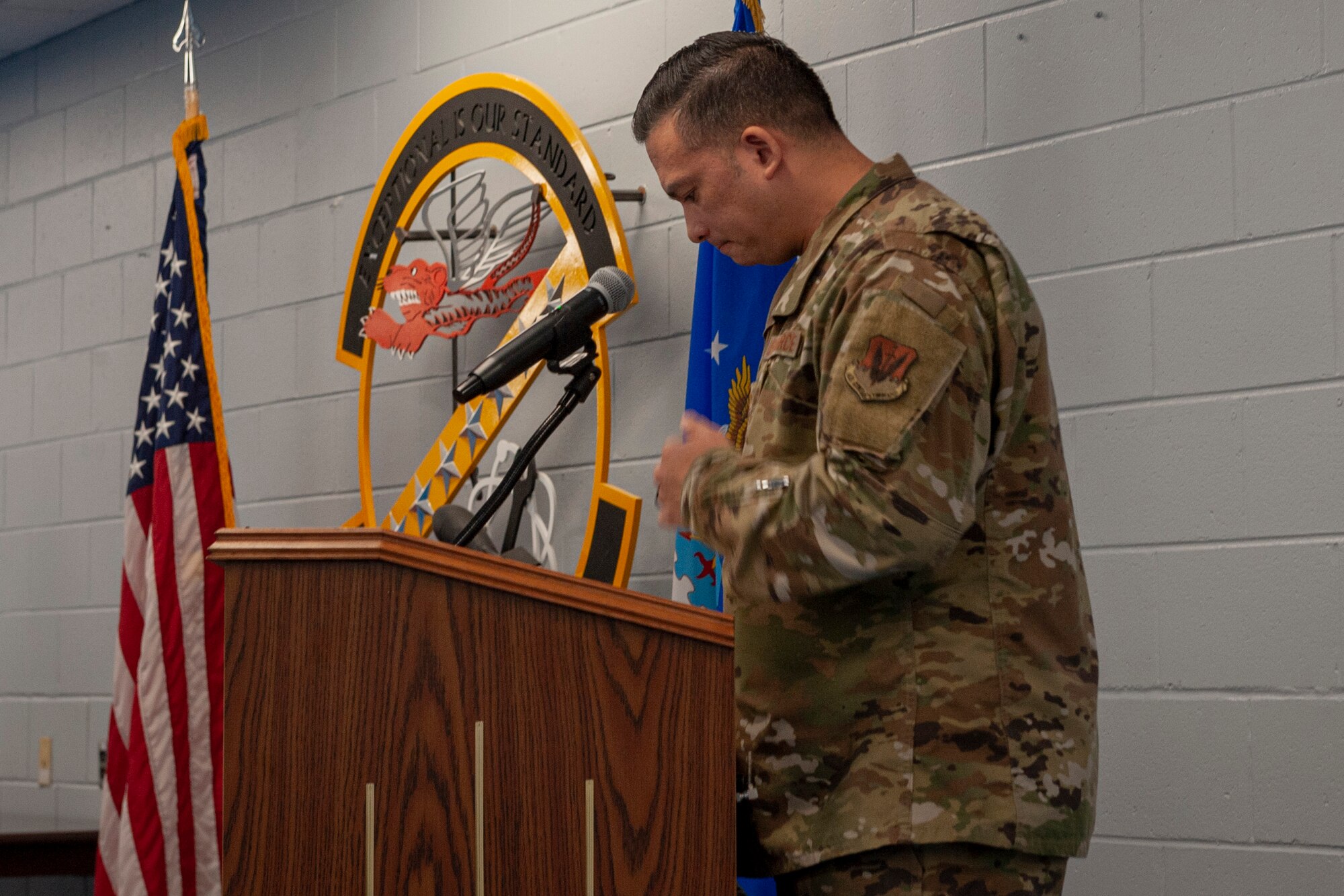 Photo of an Airman speaking at a ceremony
