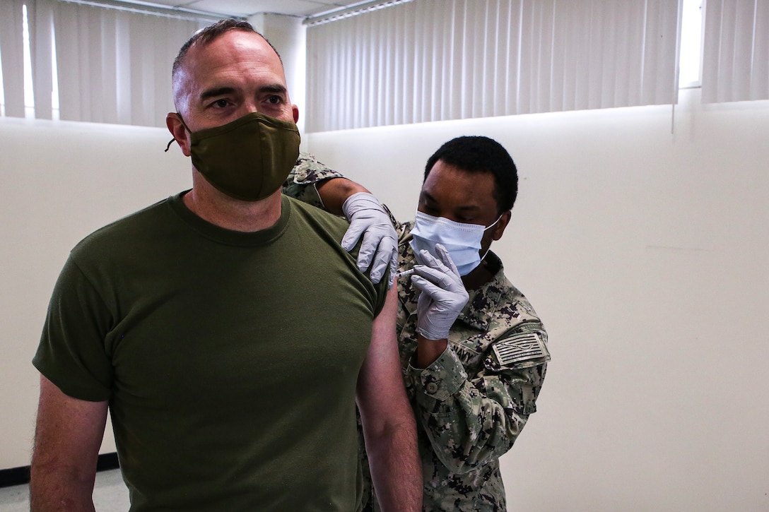 U.S. Marine Corps Col. James B. Conway, the 12th Marine Corps District Commanding Officer, receives his first COVID-19 vaccine injection at Marine Corps Recruit Depot San Diego, Calif., Jan. 25, 2021. COVID-19 vaccines are being administered in a phased approach, prioritizing healthcare workers and first responders, as welll as mission critical and deploying personnel. Vaccination distribution and prioritization within the Department of Defense, and the Marine Corps, will be consistent with the data-driven Center for Disease and Control guidance for national prioritization. (U.S. Marine Corps photo by Sgt. Christian Cachola)