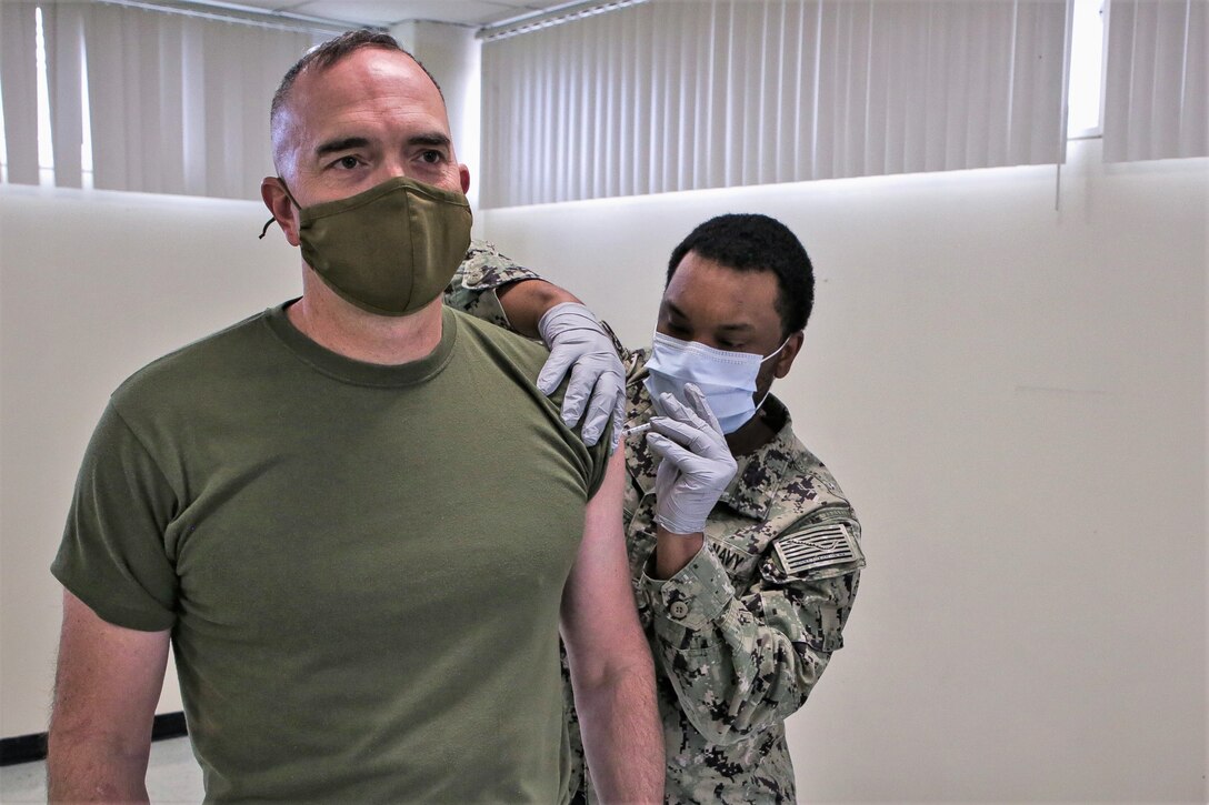 U.S. Marine Corps Col. James B. Conway, the 12th Marine Corps District Commanding Officer, receives his first COVID-19 vaccine injection at Marine Corps Recruit Depot San Diego, Calif., Jan. 25, 2021. COVID-19 vaccines are being administered in a phased approach, prioritizing healthcare workers and first responders, as well as mission critical and deploying personnel. Vaccination distribution and prioritization within the Department of Defense, and the Marine Corps, will be consistent with the data-driven Center for Disease and Control guidance for national prioritization. (U.S. Marine Corps photo by Sgt. Christian Cachola)