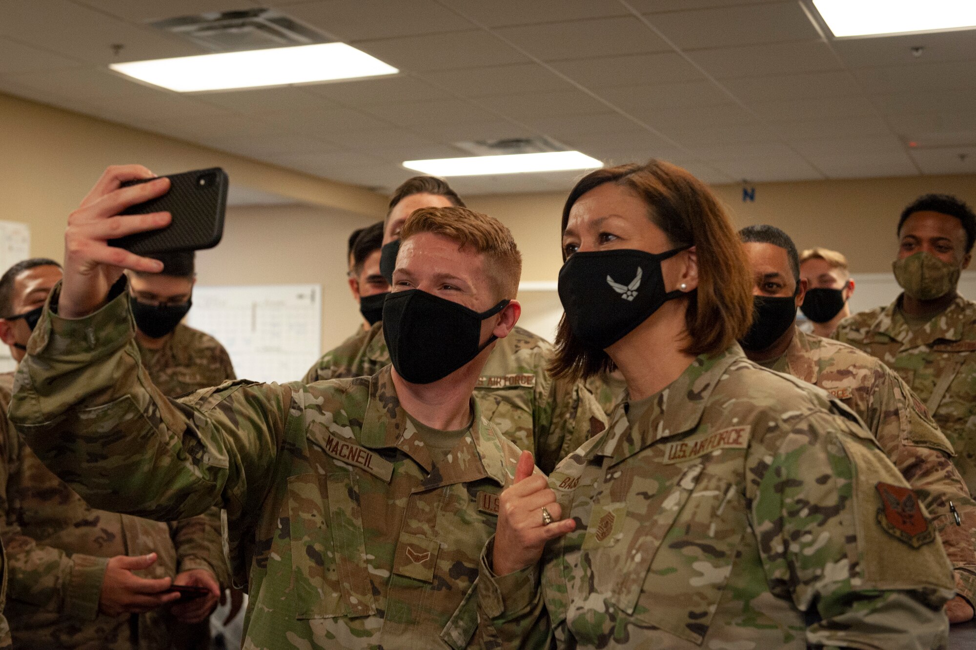 Photo of Chief Bass taking selfies with Airmen