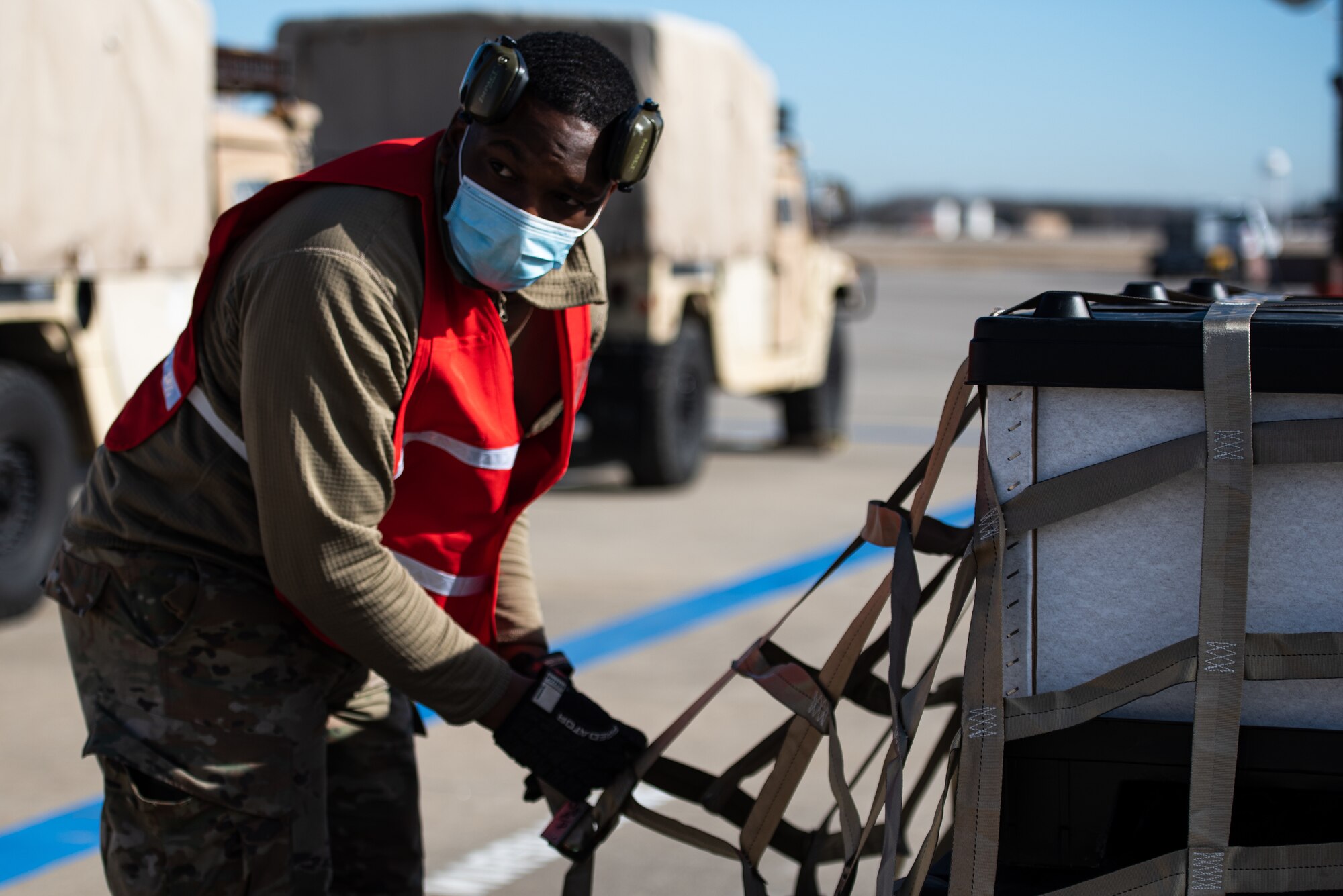 Airman looks up from securing cargo