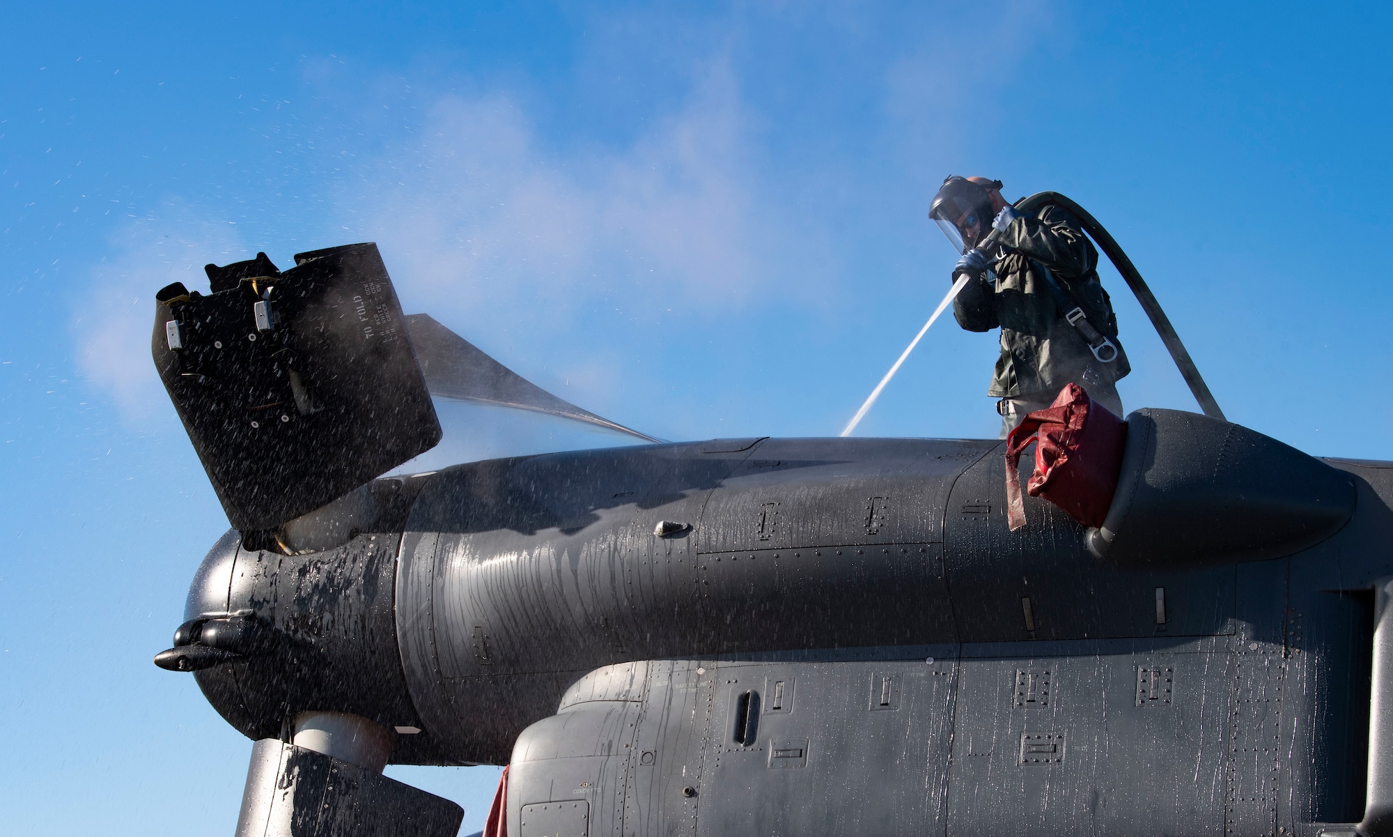 Tech. Sgt. Scott Zednick, 753rd Special Operations Aircraft Maintenance Squadron crew chief, cleans the top of a CV-22 Osprey assigned to the 21st Special Operations Squadron