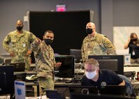 JOINT BASE LANGLEY-EUSTIS, Va. (Jan. 25, 2021) Army Maj. Ashish Patel, the chief of current operations in the Joint Operations Center at Joint Task Force Civil Support (JTF-CS), discusses response efforts with Army Col. Christopher Caldwell, the JTF-CS J3 operations director, during exercise Sudden Response 21.