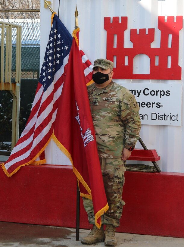 Sergeant First Class Joseph Harrison, Plans and Operations Non-Commissioned Officer, Afghanistan District, showcases the USACE Command Colors for the final time at Bagram Airfield, Afghanistan during the ceremony where the Colors will be cased.