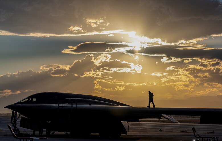 An Airman walks across B-2 Spritis.