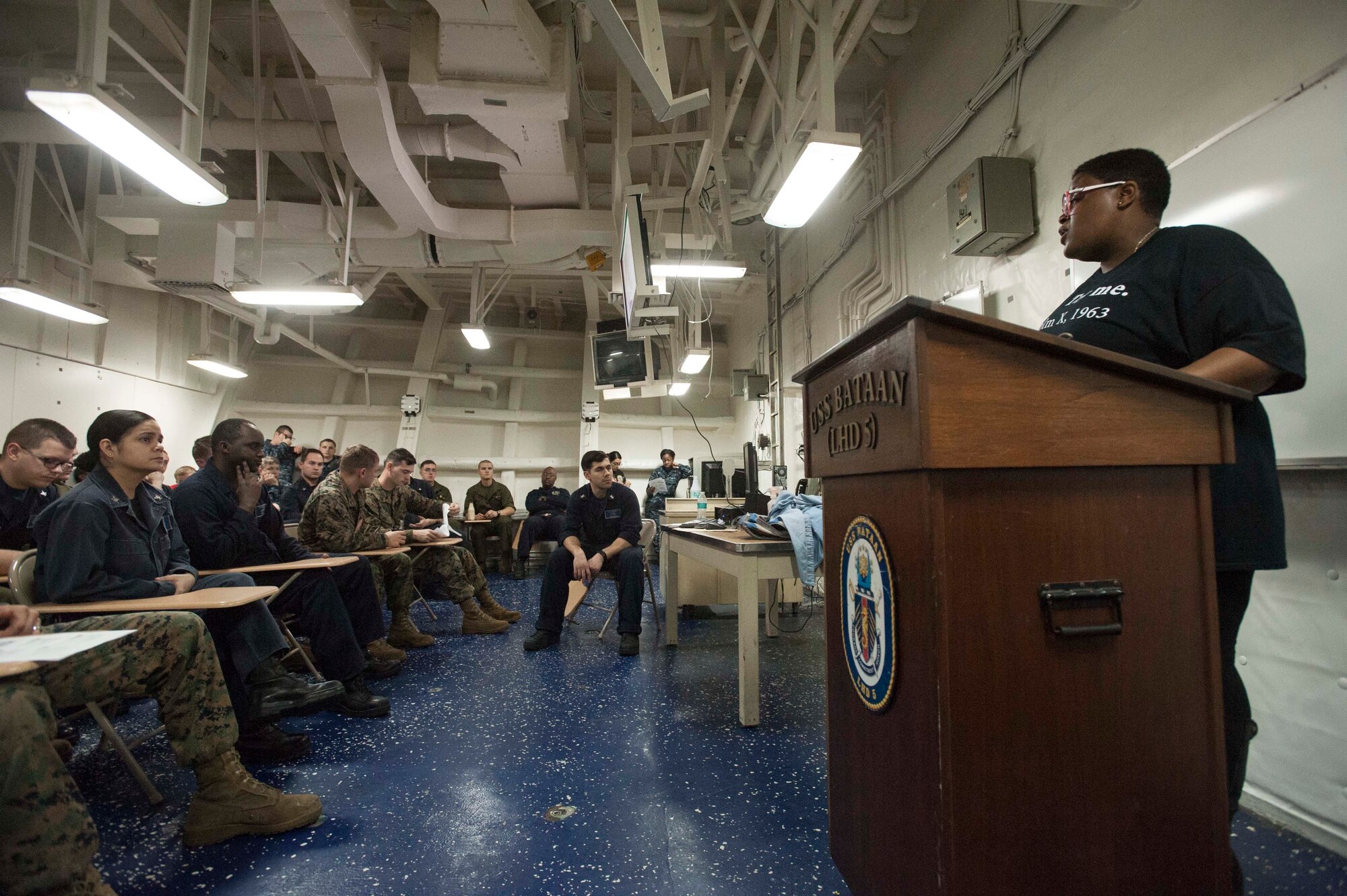 Sailors and Marines receive transgender training aboard the amphibious assault ship USS Bataan (LHD 5) from Ingrid Smith, a deployed resiliency counselor, in the ship's classroom.