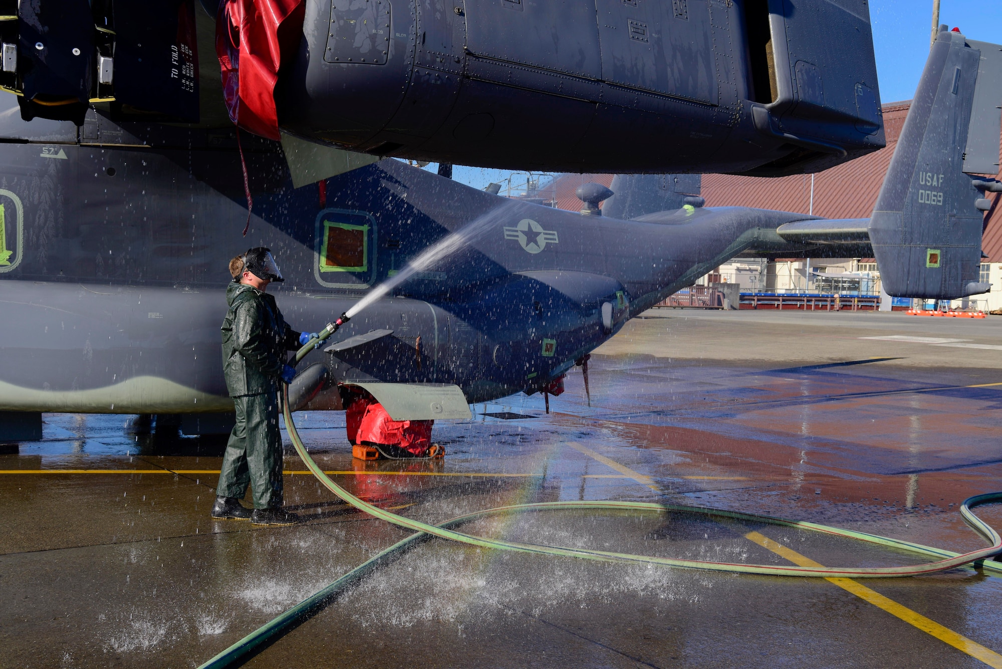 Senior Airman Brody Lee, 753rd Special Operations Aircraft Maintenance Squadron crew chief, cleans a wing of a CV-22 Osprey assigned to the 21st Special Operations Squadron at Yokota Air Base