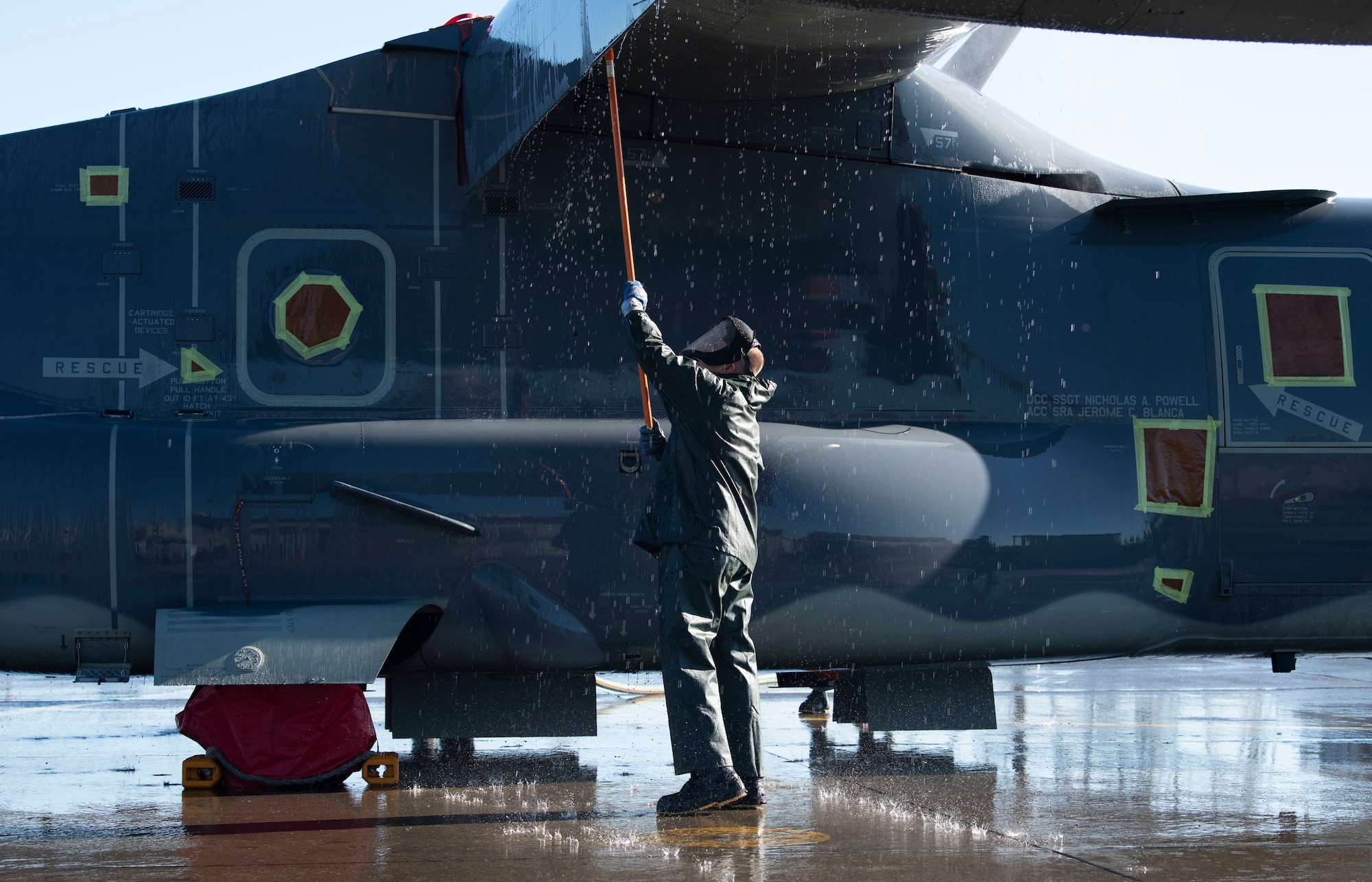 Senior Airman Brody Lee,753rd Special Operations Aircraft Maintenance Squadron crew chief, cleans a wing of a CV-22 Osprey assigned to the 21st Special Operations Squadron at Yokota Air Base