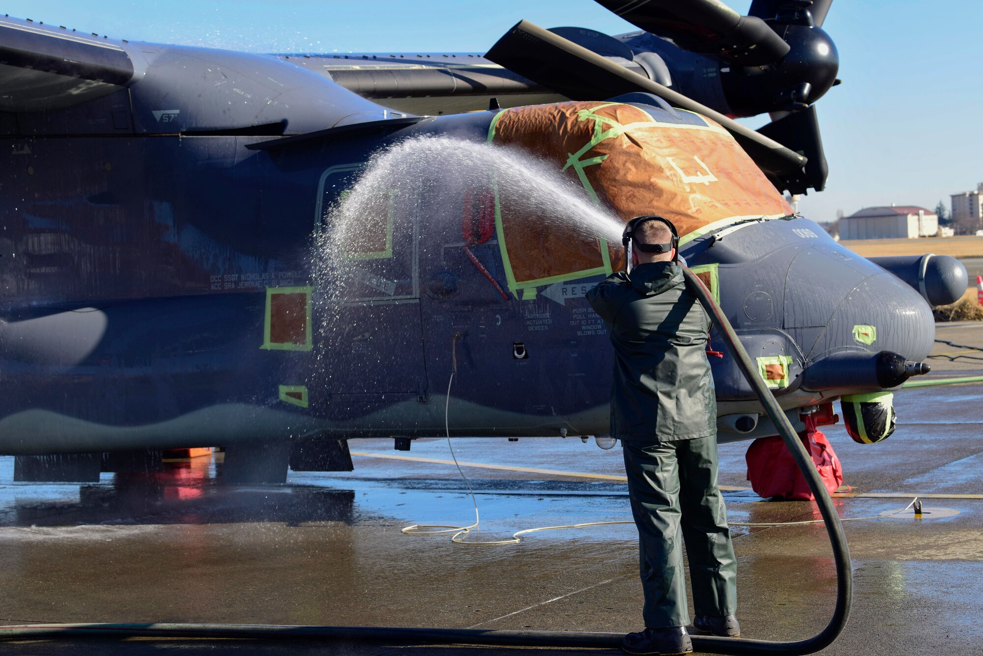 Senior Airman Brody Lee, 753rd Special Operations Aircraft Maintenance Squadron crew chief, cleans a side of a CV-22 Osprey assigned to the 21st Special Operations Squadron