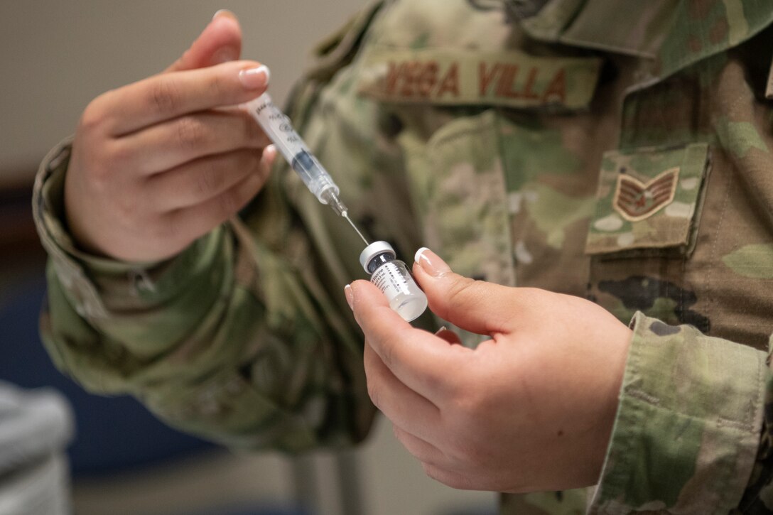 A 412th Medical Group technician prepares a vial of COVID-19 vaccine Jan. 22, 2021 at Edwards Air Force Base, Calif. The COVID-19 vaccine distribution at Edwards AFB moved to the next tier of the distribution phase by vaccinating mission-essential personnel. (U.S. Air Force photo by Tech. Sgt. Robert Cloys)