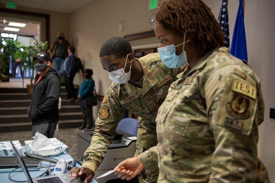 Airmen from the 412th Medical Group register the next tier of mission-essential personnel before administering the COVID-19 vaccine. All Defense Department personnel are encouraged to take the vaccine to protect their health, their families and their communities and to lower the public health risks associated with the COVID-19 pandemic. (U.S. Air Force photo by Tech. Sgt. Robert Cloys)