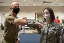 Maj. Gen. Christopher Azzano, Air Force Test Center commander, thanks Airman 1st Class Kendall Timko, 412th Medical Group medical technician after receiving the COVID-19 vaccine, Jan. 22, 2021 at the Airman and Family Readiness Center on Edwards Air Force Base, Calif. After vaccination, Defense Department personnel will continue to wear appropriate masks, practice physical distancing, wash hands and follow restrictions of movement in order to protect the safety of others as a large portion of the population will need to be vaccinated before COVID-19 risks diminish. (U.S. Air Force photo by Tech. Sgt. Robert Cloys)