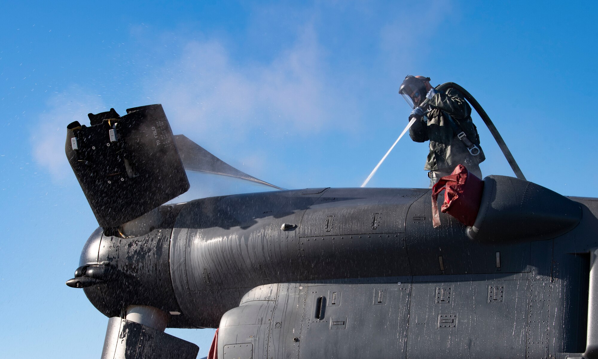 Tech. Sgt. Scott Zednick, 753rd Special Operations Aircraft Maintenance Squadron crew chief, cleans the top of a CV-22 Osprey assigned to the 21st Special Operations Squadron