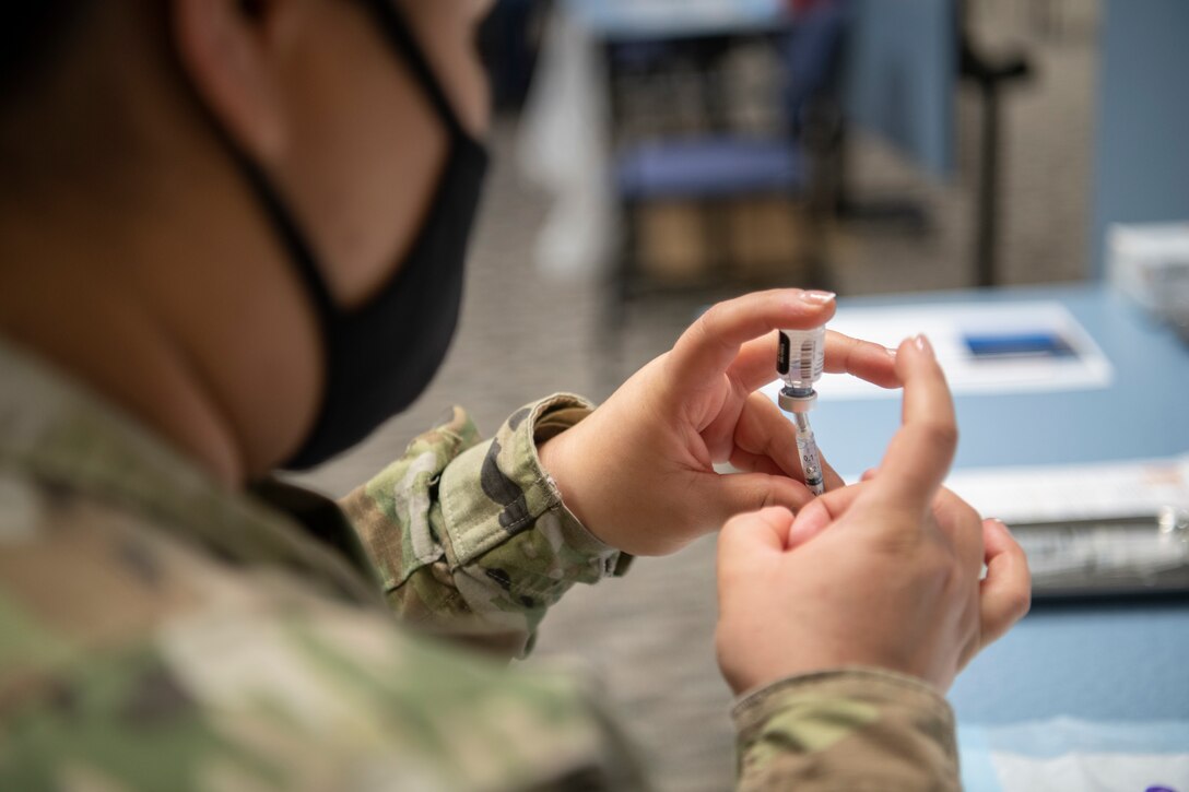 Medical tech preparing vaccine