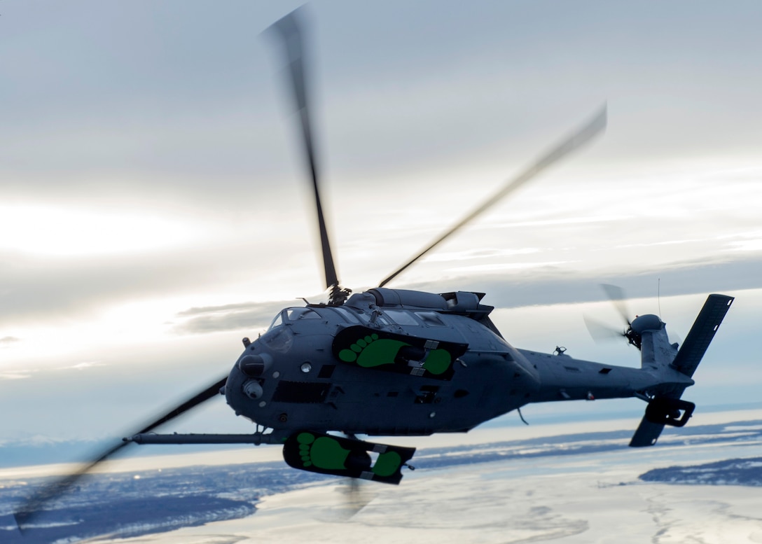 A U.S Air Force HH-60G Pave Hawk helicopter assigned to the 210th Rescue Squadron, Alaska Air National Guard, conducts aerial refueling from a U.S. Air Force HC-130J Combat King II assigned to the 211th Rescue Squadron, Alaska Air National Guard, over Alaska, Jan. 21, 2021, during Operation Noble Defender. Operation Noble Defender is a North American Air Defense Command air-defense operation which allows dynamic training for operational readiness in an arctic environment.