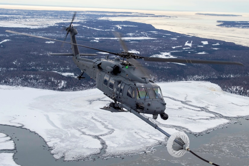 A U.S Air Force HH-60G Pave Hawk helicopter assigned to the 210th Rescue Squadron, Alaska Air National Guard, conducts aerial refueling from a U.S. Air Force HC-130J Combat King II assigned to the 211th Rescue Squadron, Alaska Air National Guard, over Alaska, Jan. 21, 2021, during Operation Noble Defender. Operation Noble Defender is a North American Air Defense Command air-defense operation which allows dynamic training for operational readiness in an arctic environment.