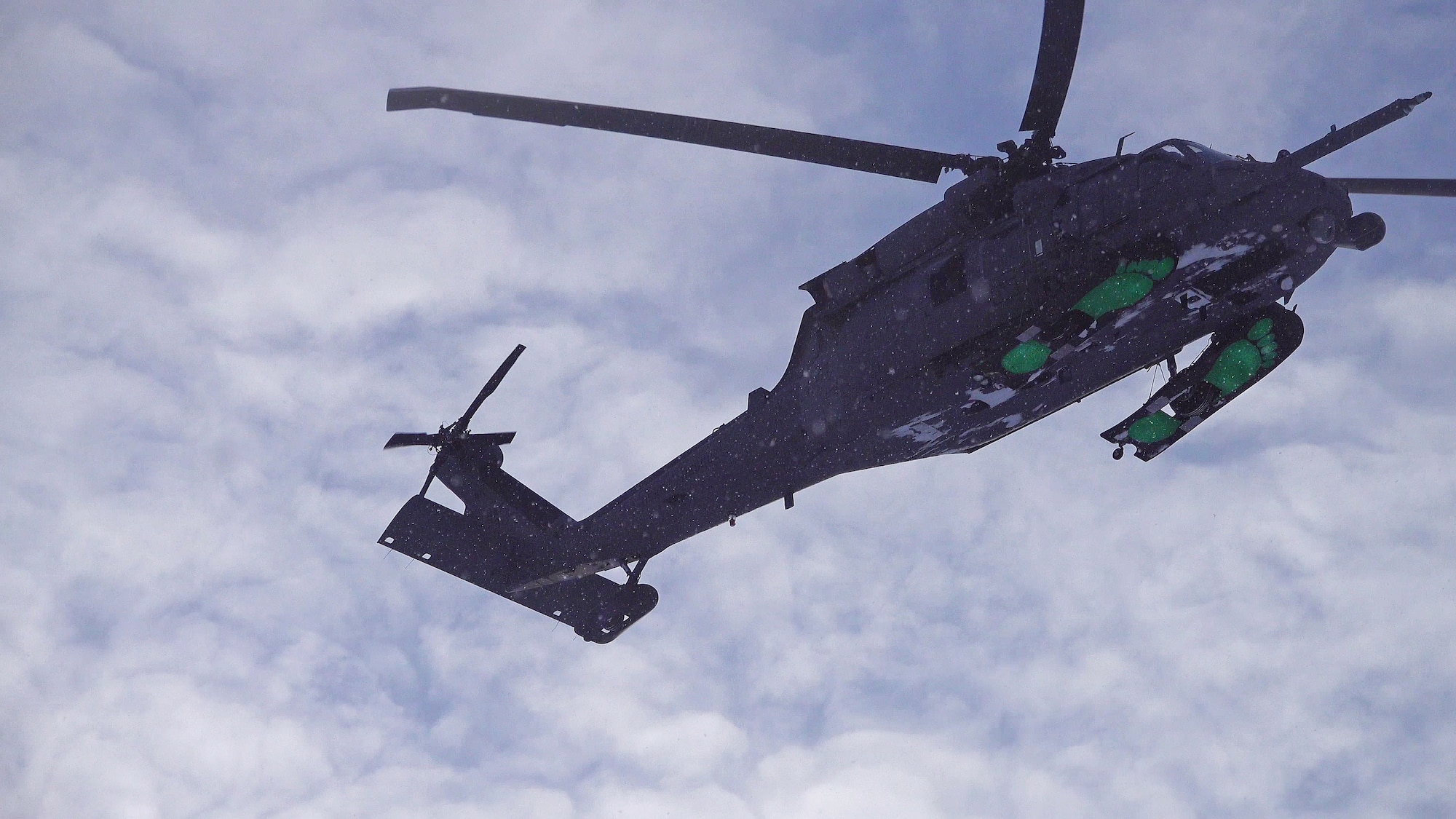 HH-60G Pave Hawk aircrew of 210th Rescue Squadron simulate combat search-and-rescue tactics by locating and evacuating a simulated downed pilot in southcentral Alaska Jan. 21, 2021, as part of Operation Noble Defender. The exercise is a North American Air Defense Command Arctic air defense operation.