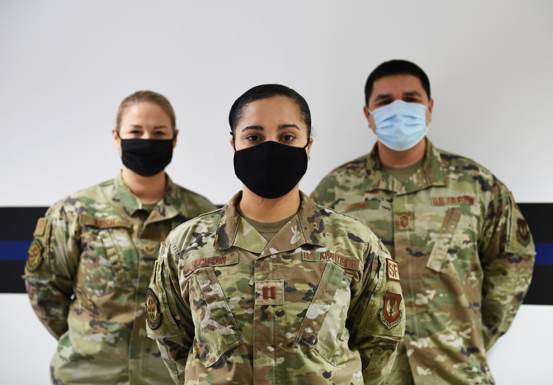 U.S. Air Force Capt. Raven Jackson is joined by two members of her team, Staff Sgt. Briana Aston and Senior Master Sgt. Samuel Jalomo, Jan. 8, 2021.