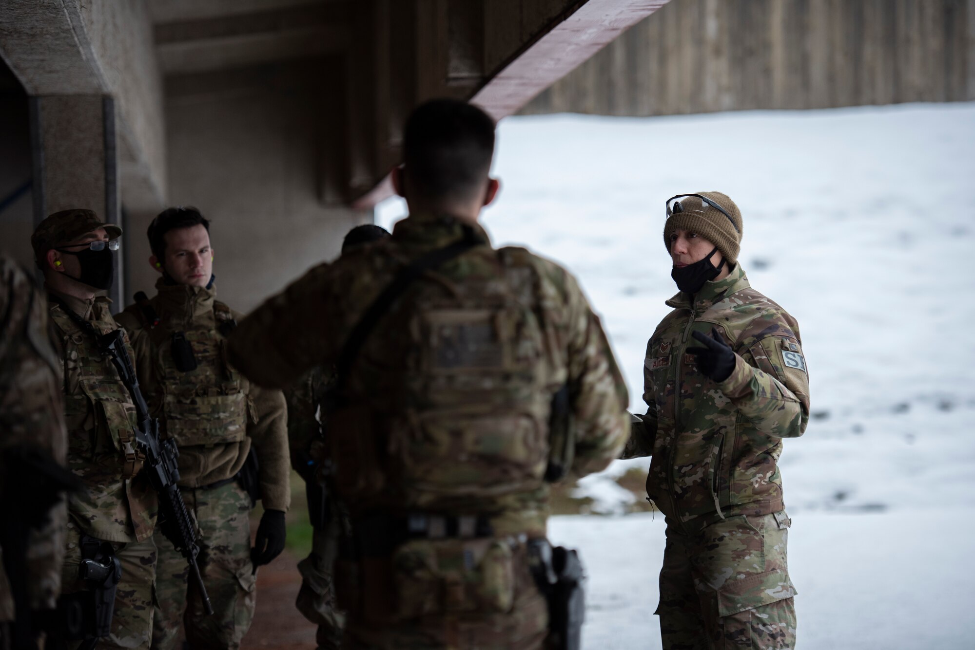 U.S. Air Force Staff Sgt. Madison Alicea, 569th U.S. Forces Police Squadron training instructor, right, briefs a 569th unit at Breitenwald Landstuhl Range, Germany, Jan. 20, 2021.