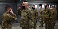 Capt. Shawn Slaney, left, assumes command of the 172nd Law Enforcement Detachment from Sgt. 1st Class Charlie Winn during a sendoff ceremony in Williston, Vermont, Jan. 25, 2021. The detachment, part of the Vermont National Guard's Garrison Support Command, will deploy to support U.S. European Command operations until 2022. Slaney is the detachment commander; Winn is the detachment first sergeant. (U.S. Army National Guard photo by Don Branum)