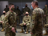 Capt. Shawn Slaney salutes Maj. Gen. Greg Knight after receiving a Vermont battle flag during a send-off ceremony for the 172nd Law Enforcement Detachment Jan. 25, 2021, in Williston, Vermont. The 172nd LED, part of the Vermont National Guard's Garrison Support Command, will spend a year supporting U.S. European Command. Knight is the adjutant general for Vermont; Slaney is the 172nd LED commander. (U.S. Army National Guard photo by Don Branum)