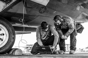 An Airman instructs another Airman during training.