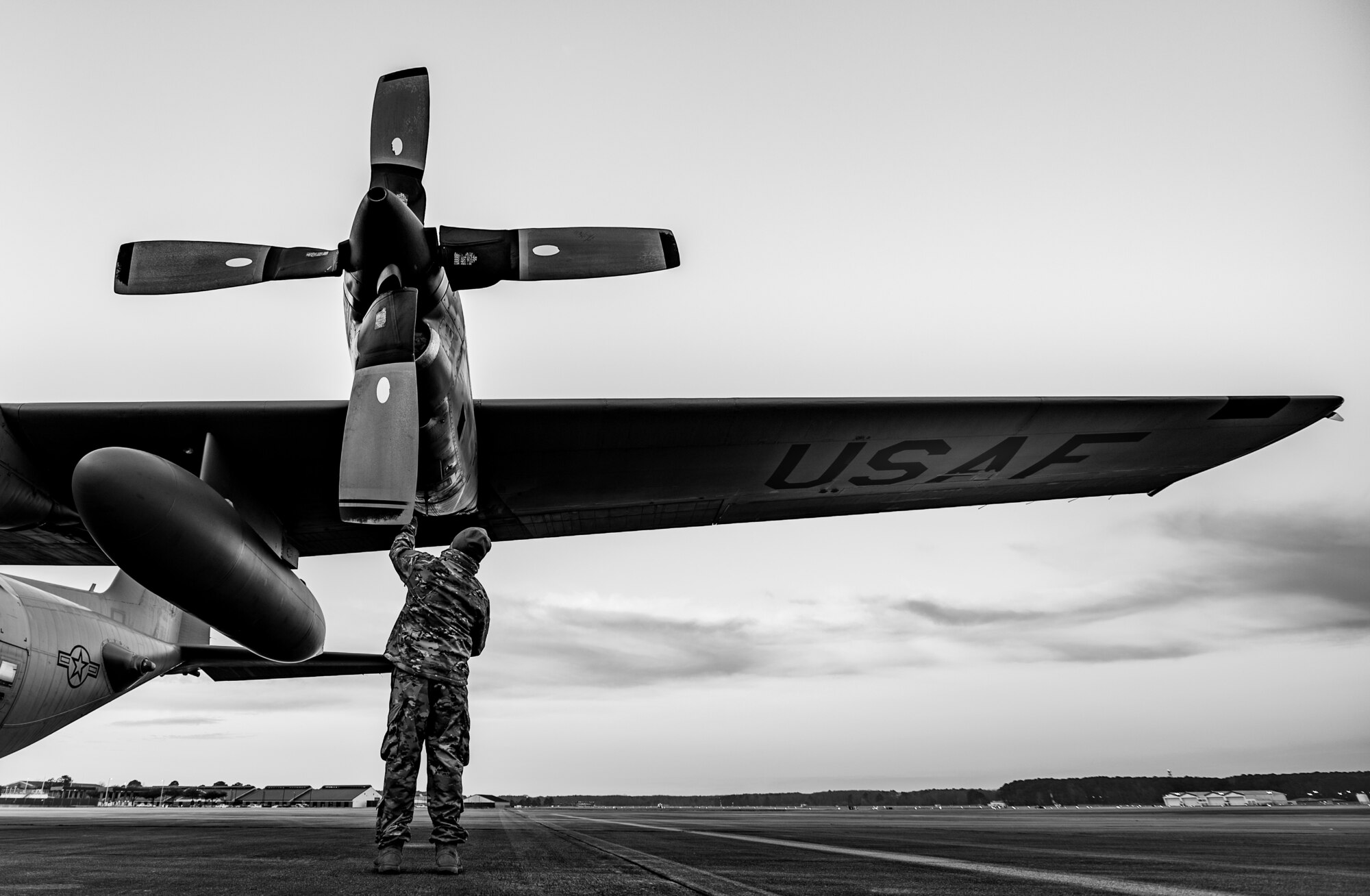 An airmen inspects an aircraft on the flight line.
