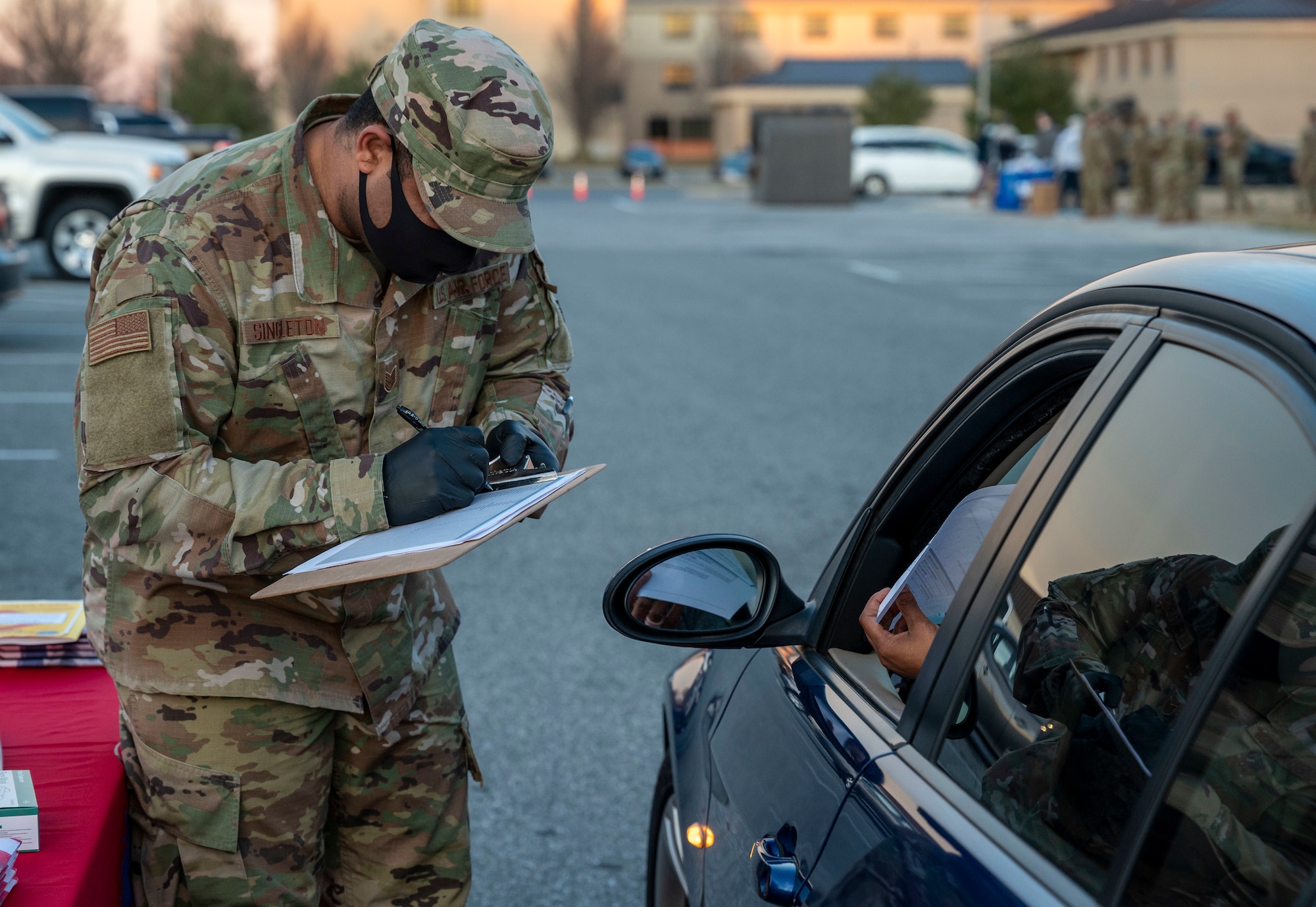 Tech. Sgt. Dominique Singleton, 436th Force Support Squadron readiness flight noncommissioned officer in charge, marks off an attendance roster at a deployed spouses drive-thru dinner at Dover Air Force Base, Delaware, Jan. 21, 2021. The event provided meals, gift bags and toys to families of deployed service members in recognition of their sacrifice. The deployed spouses dinner is one of many ways Team Dover takes care of service members and their loved ones. (U.S. Air Force photo by Airman 1st Class Cydney Lee)