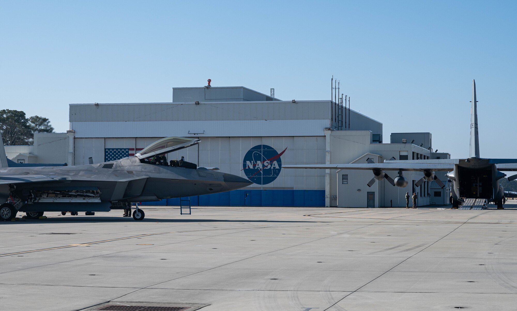 Aircraft sit on a flight line.