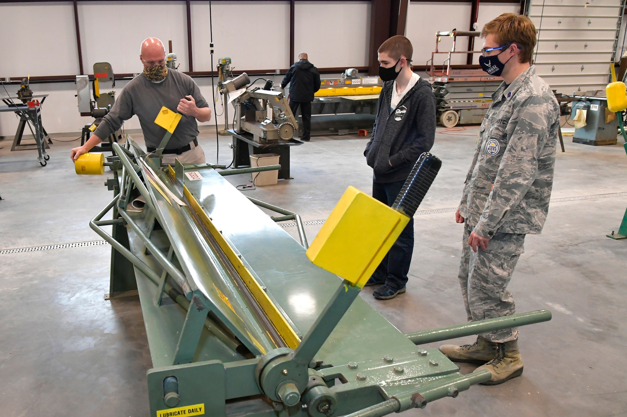 (Left to right) Darrel Gronau, aviation structure repair instructor, teaches metal forming and tool safety to Isaac Jensen and Connor Innocenzi, both Utah Military Academy students.