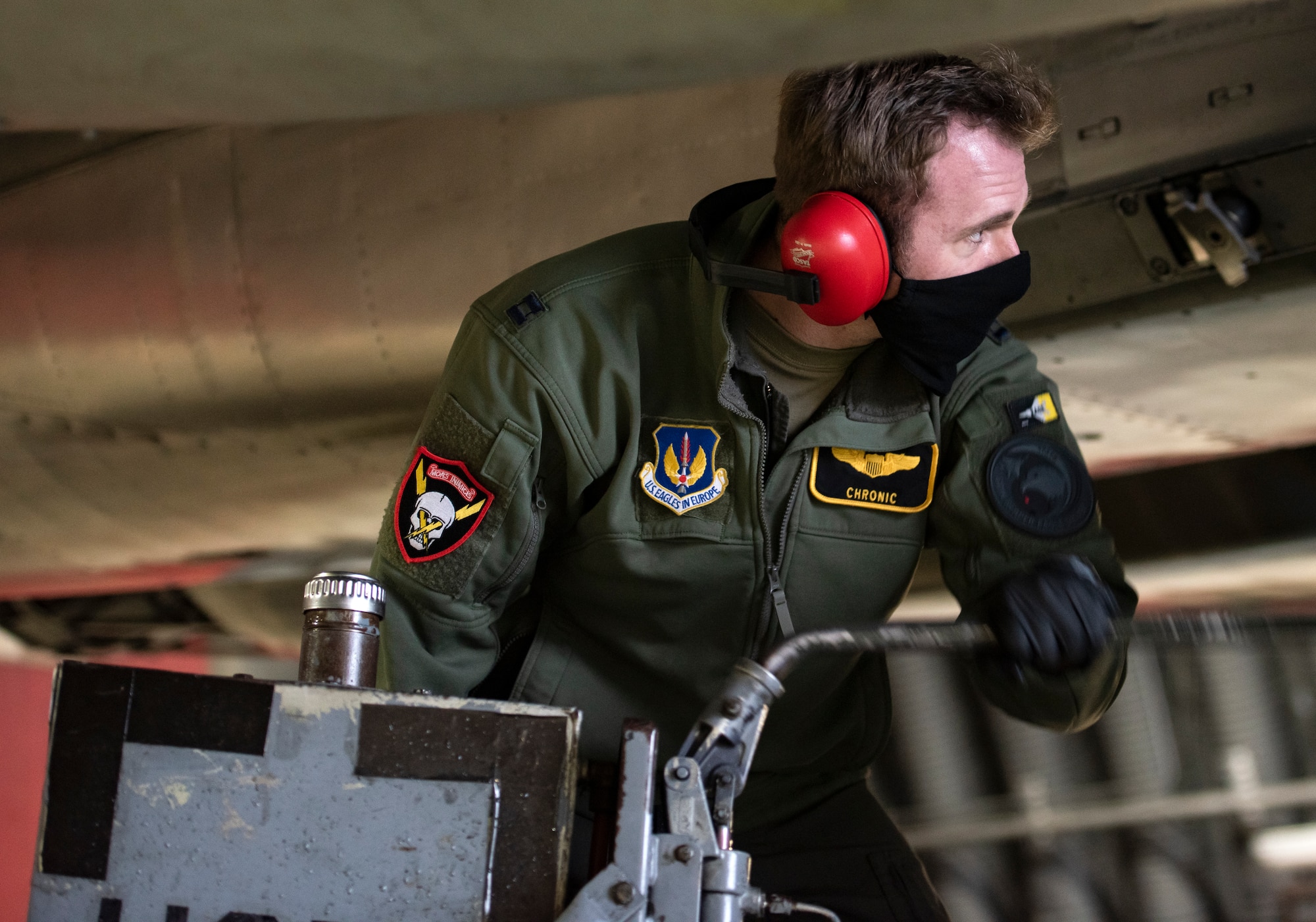 U.S. Air Force Capt. Cameron Emerson, 493rd Fighter Squadron F-15C Eagle pilot, assists with pre-flight maintenance at Royal Air Force Lakenheath, England, Jan. 21, 2021. The 48th Fighter Wing is dedicated to developing a force of multi-capable Airmen to drive the mission more effectively through the integration of Agile Combat Employment concepts. (U.S. Air Force photo by Airman 1st Class Jessi Monte)