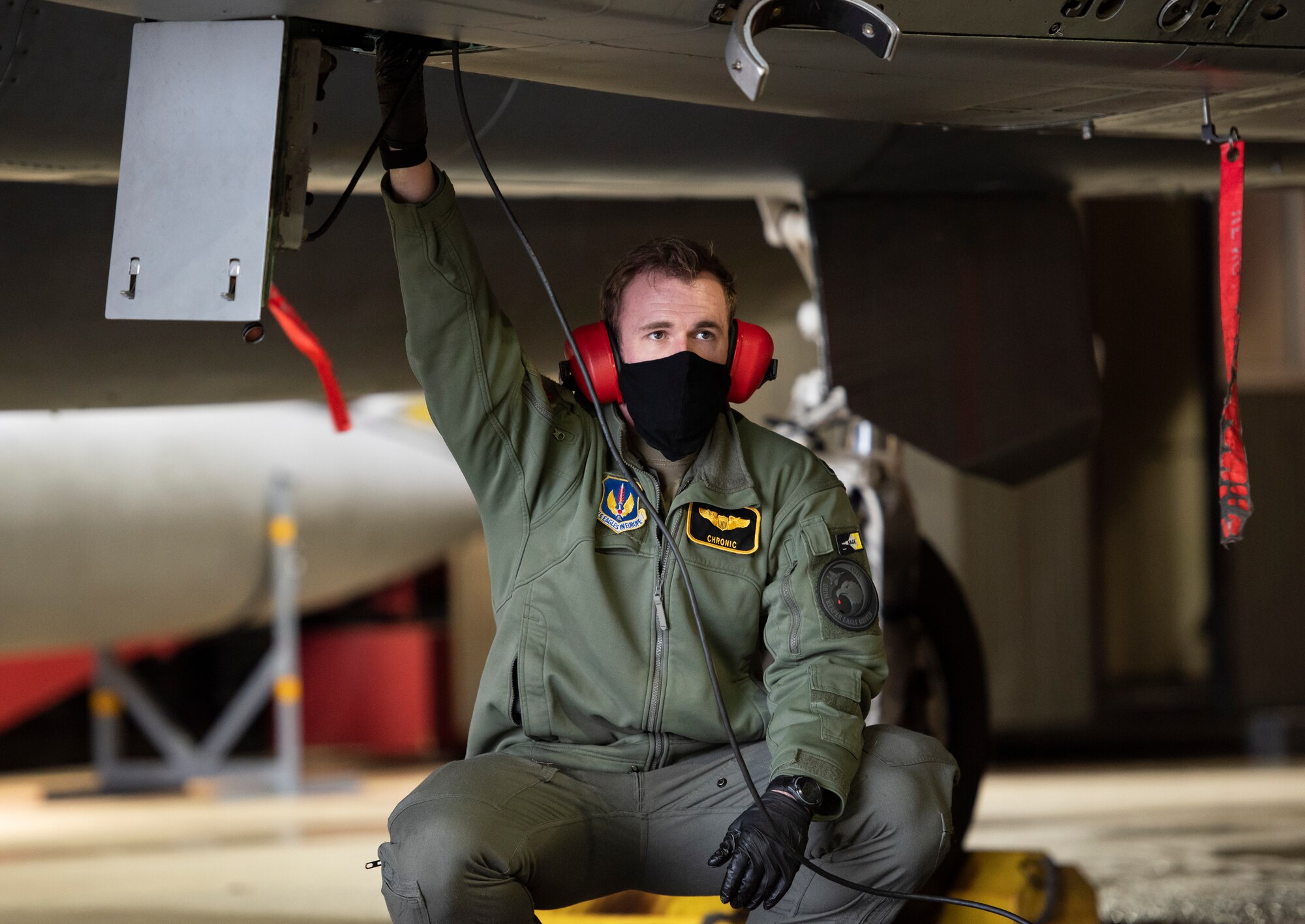 U.S. Air Force Capt. Cameron Emerson, 493rd Fighter Squadron F-15C Eagle pilot, assists with pre-flight checks at Royal Air Force Lakenheath, England, Jan. 21, 2021. The 48th Fighter Wing is dedicated to developing a force of multi-capable Airmen to drive the mission more effectively through the integration of Agile Combat Employment concepts. (U.S. Air Force photo by Airman 1st Class Jessi Monte)