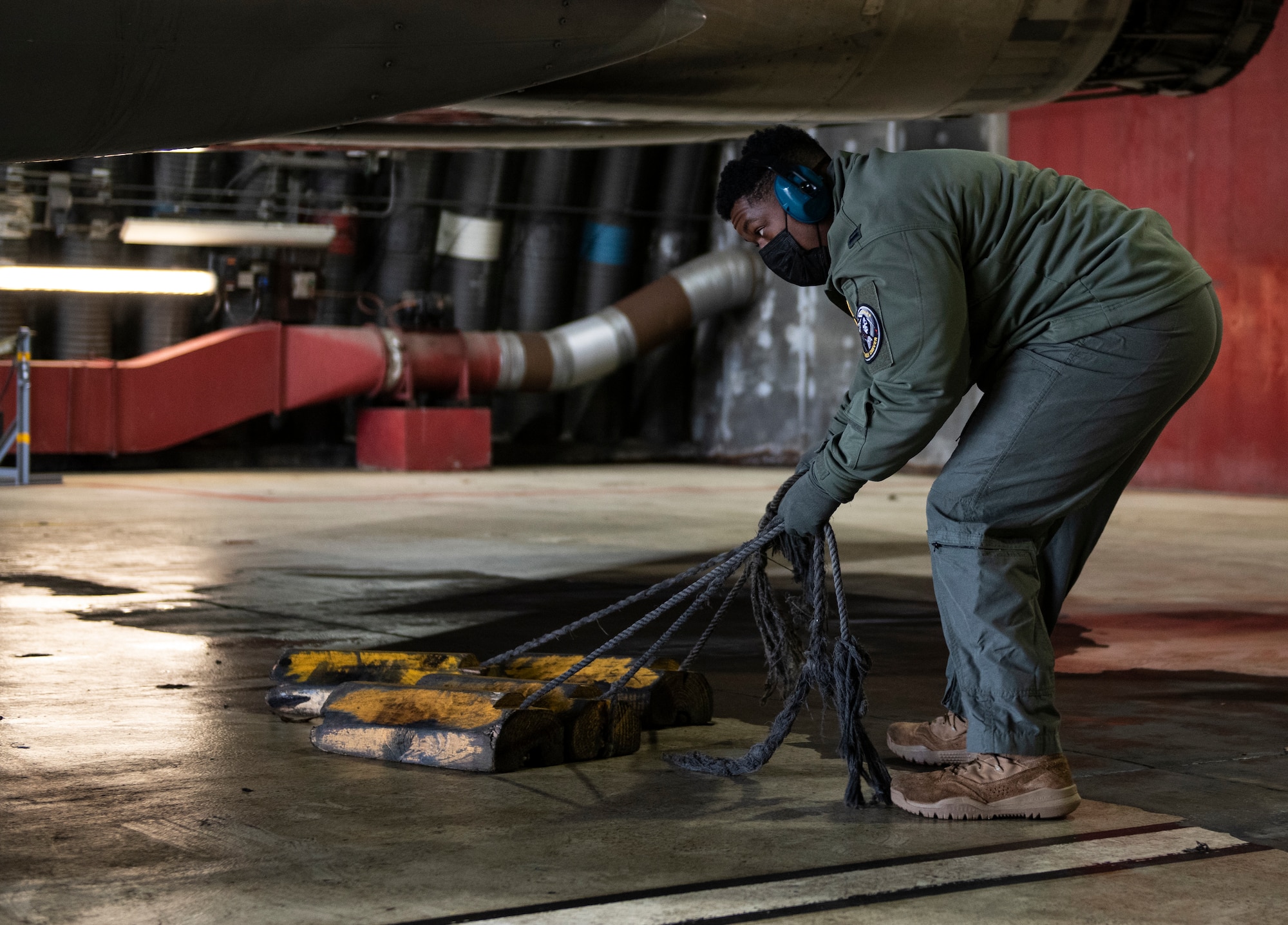 U.S. Air Force Capt. Joshua Jones, 493rd Fighter Squadron F-15C Eagle pilot, removes chocks from an aircraft prior to take-off at Royal Air Force Lakenheath, England, Jan. 21, 2021. Aircrew and other Airmen and Aircrew from non-maintenance career fields recently had the opportunity to practice Agile Combat Employment concepts while helping generate sorties for the 493rd FS. (U.S. Air Force photo by Airman 1st Class Jessi Monte)