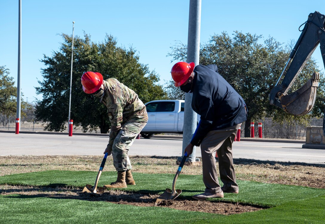 Col. Ed Sumangil, 7th Bomb Wing commander, left, and Anthony Williams, Abilene mayor, break ground at the Visitor Control Center’s groundbreaking ceremony at Dyess Air Force Base, Texas, Jan. 25, 2021.