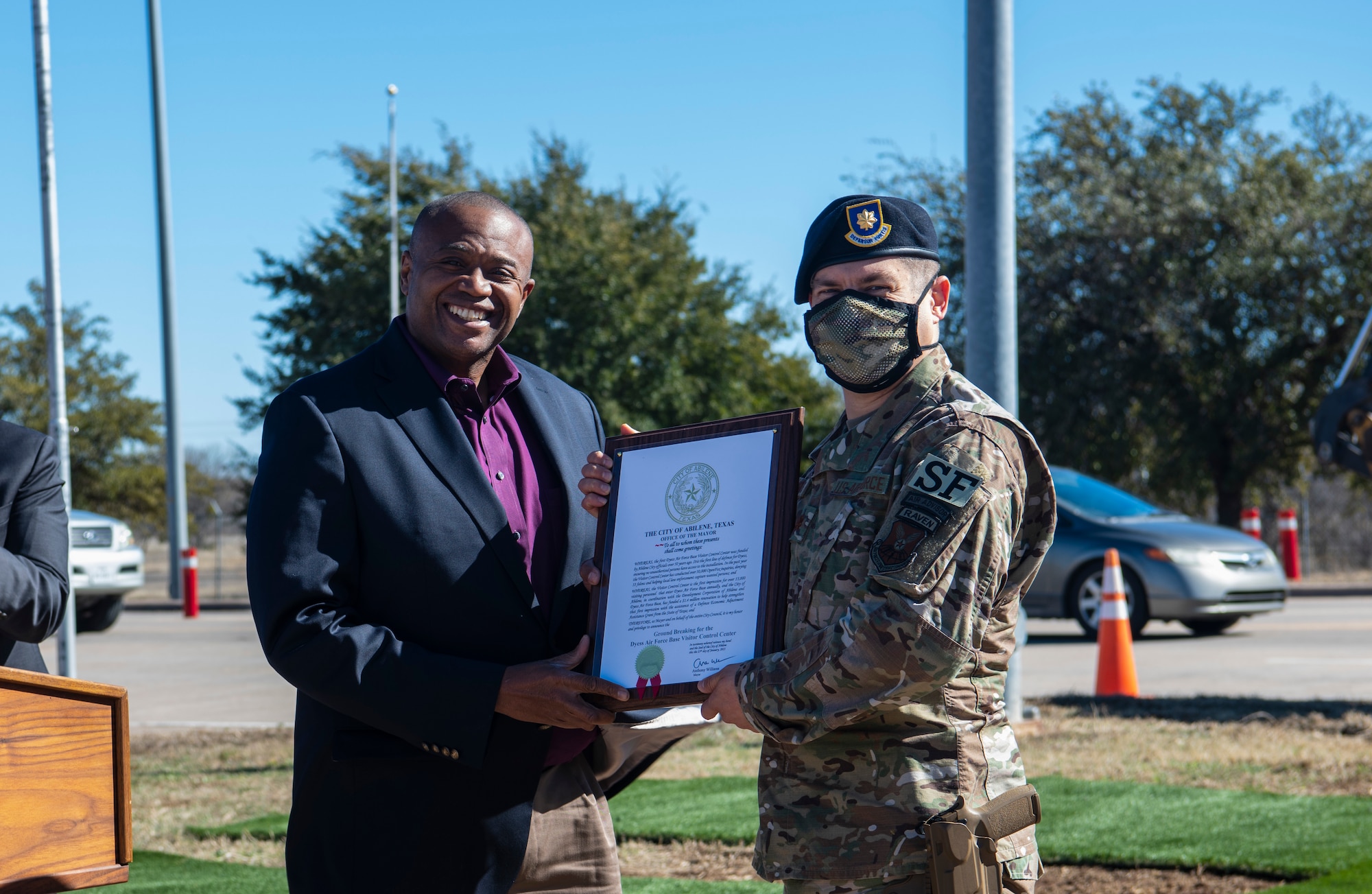 Maj. Michael Morriss, 7th Security Forces Squadron commander, right, receives the Visitor Control Center’s groundbreaking proclamation from Anthony Williams, Abilene mayor, at Dyess Air Force Base, Texas, Jan. 25, 2021.