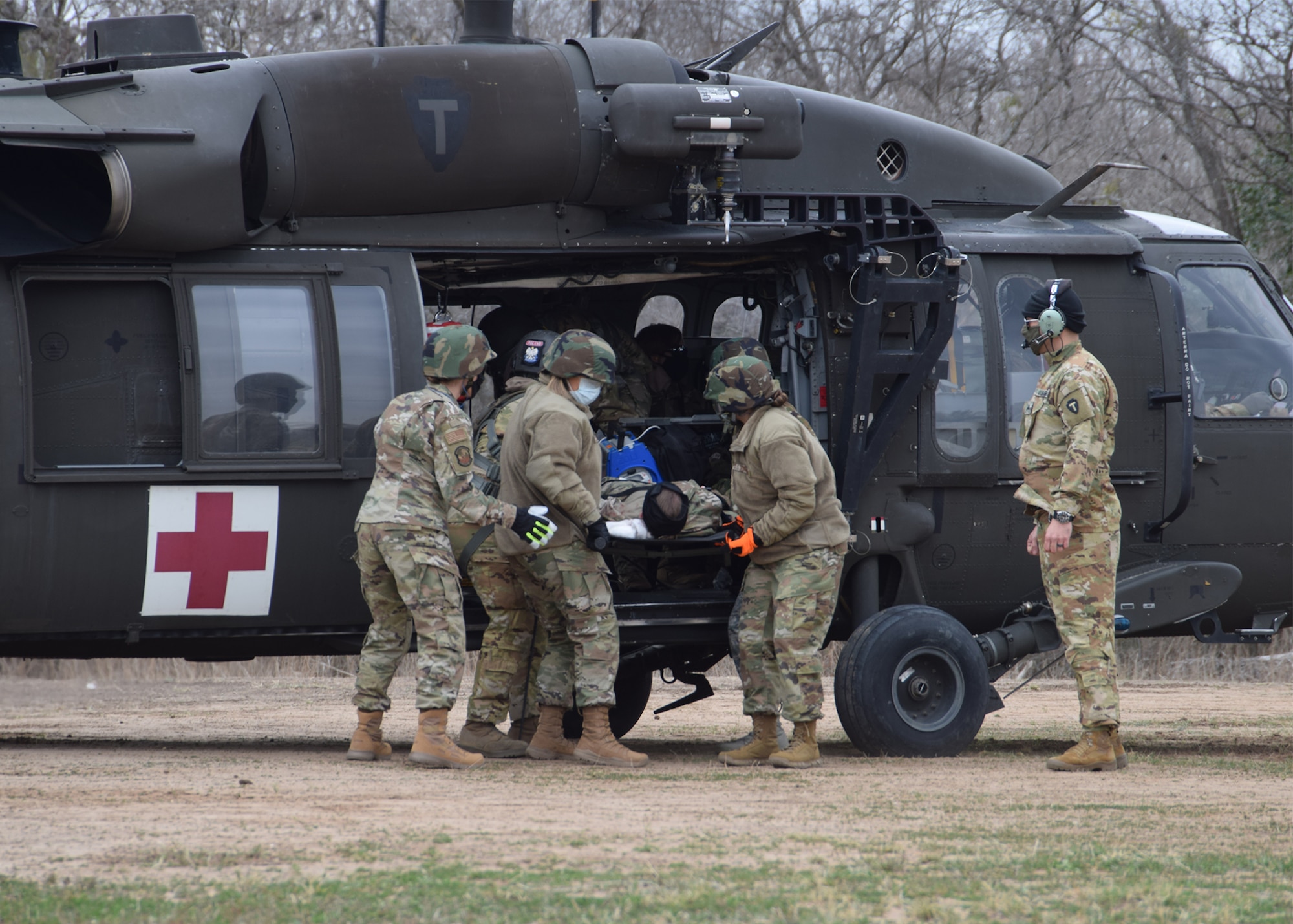 Reserve Citizen Airmen from the 433rd Aeromedical Staging Squadron conduct training in offloading and receiving incoming patients on a UH-60 Black Hawk helicopter Jan. 9, 2021 at Joint Base San Antonio-Chapman Training Annex. The training opportunity provided first time experience to personnel working on the ground. (U.S. Air Force photo by Tech. Sgt. Iram Carmona)