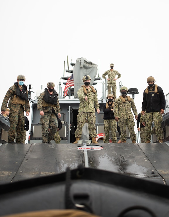 U.S. Marines with the All Domain Reconnaissance Detachment, 11th Marine Expeditionary Unit (MEU), operate a Combat Rubber Raiding Craft (CRRC) onto a Mark VI patrol boat assigned to Maritime Expeditionary Security Squadron 3, during a combatant dive exercise at Marine Corps Base Camp Pendleton, California, Jan. 6, 2020. The training improved proficiency utilizing CRRCs for insertion and extraction during combatant dive operations, and improved interoperability working with the Mark VI patrol boat platform to facilitate potential special mission requirements on the 11th MEU’s upcoming deployment. (U.S. Marine Corps photo by Sgt. Jennessa Davey)
