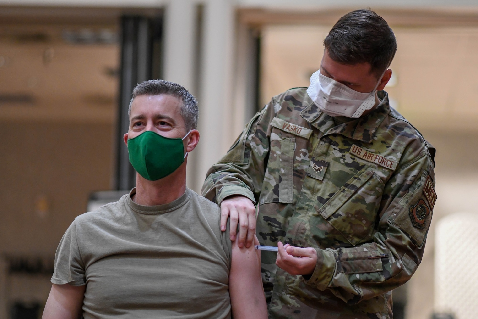 Col. Richard Tanner, 22nd Air Refueling Wing commander, receives his first round of the COVID-19 vaccine from Senior Airman Stephen Vasko, 22nd Medical Operations Squadron aerospace medical technician, Jan. 21, 2021, at McConnell Air Force Base, Kansas. The Department of Defense’s priority with the vaccine is to ensure all uniformed personnel, DOD civilians and their families are able to safeguard national security and support the whole-of-government response to the COVID-19 Pandemic. (U.S. Air Force photo by Senior Airman Nilsa Garica)